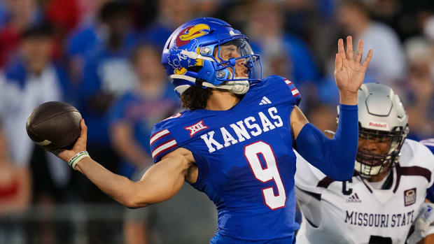 Sep 1, 2023; Lawrence, Kansas, USA; Kansas Jayhawks quarterback Jason Bean (9) throws a pass against Missouri State Bears defensive lineman Darion Smith (2) during the first half at David Booth Kansas Memorial Stadium. 